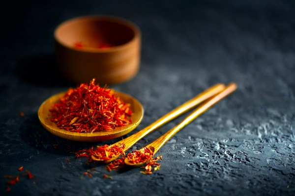 Red saffron powder in wooden container